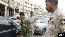 Awakening Council militia man a checkpoint in Baghdad.