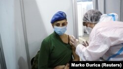 A Serbian army officer receives a dose of the Sinopharm vaccine as the country intensifies a mass inoculation campaign by sourcing several vaccines. 