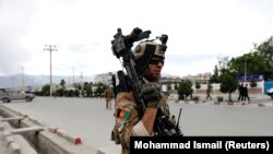 An Afghan soldier stands guard at the site of a blast in Kabul on May 30.