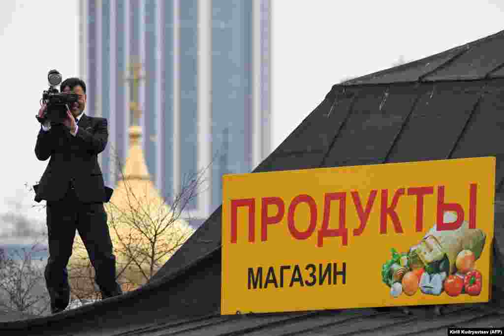 A North Korean cameraman takes up a position on the roof of a building near Vladivostok&#39;s train station.&nbsp;