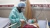 Coronavirus patient with nurse in Iran