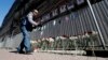 A man lays flowers and pays tribute to medical workers who have died from COVID-19 at a makeshift memorial in front of the local health department in St. Petersburg, Russia.