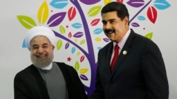 Iran's President Hassan Rouhani, left, and Venezuela's President Nicolas Maduro, shake hands during the inauguration of the 17th Non-Aligned Movement Summit in Porlamar, Venezuela, Saturday, Sept. 17, 2016. (AP Photo/Ariana Cubillos)