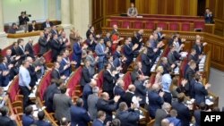 Ukrainian Foreign Minister Pavlo Klimkin (top right) and Verkhovna Rada deputies react after a vote for a bill dropping Ukraine's nonaligned status in Kyiv on December 23.