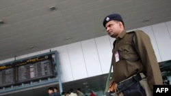 An paramilitary officer stands guard at the airport in New Delhi, where India said security was "adequate."