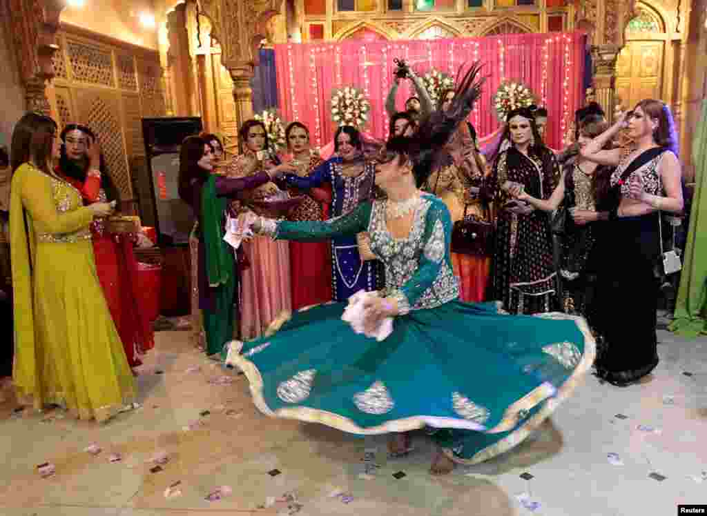 Members of the transgender community attend a birthday party in Peshawar. Armed police guarded the door. Transgender people in Pakistan run the risk of violence in the conservative Muslim country, where they often work as dancers at weddings and other parties but are rarely allowed to hold their own celebrations. (Reuters/Caren Firouz)