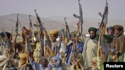 Pakistan -- Baluch rebels hold their weapons as they pose for a photograph at an undisclosed location in Baluchistan province, undated