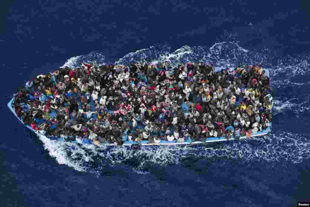 Massimo Sestini, an Italian photographer, won Second Prize in the General News Category, Singles,&nbsp;​with this image of shipwrecked people being rescued aboard a boat 32 kilometers north of Libya by a frigate of the Italian navy.