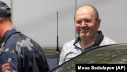 Oyub Titiyev (right) leaves court after a hearing in Grozny on July 3. 