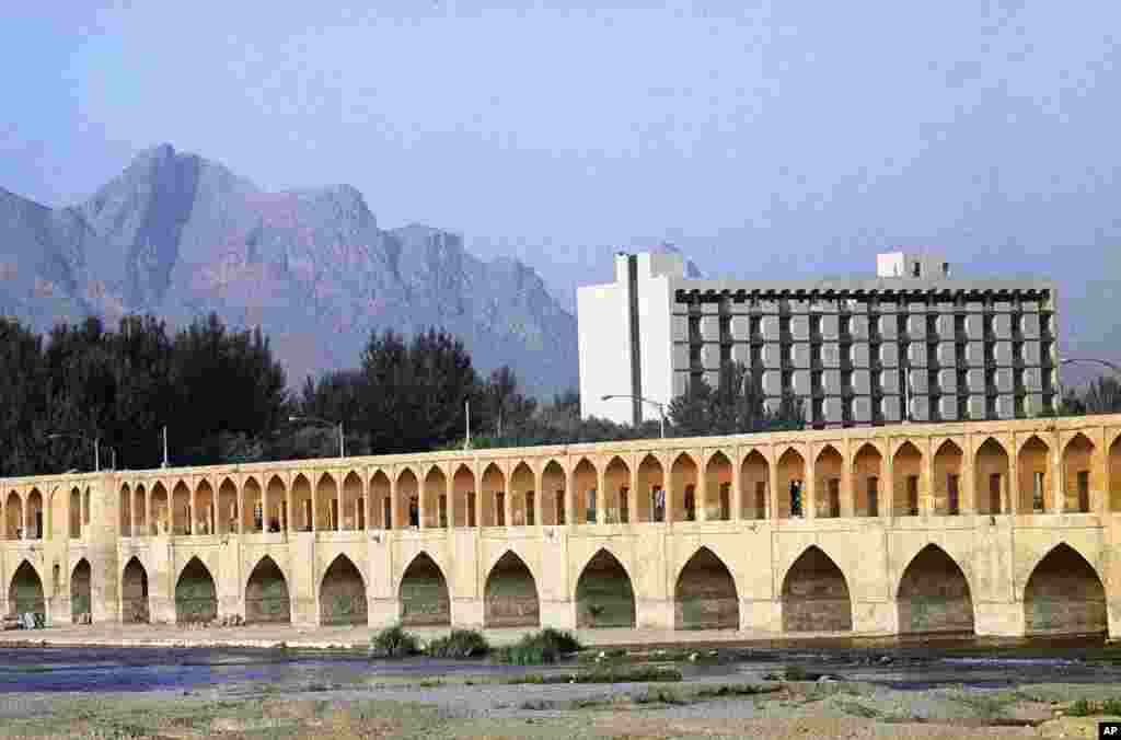 "The bridge of 33 arches," built in 1602, contrasts with a modern office building and the jagged peaks of Kuh I Sofeh Mountain in Isfahan, Iran, July 1971. (AP Photo/Horst Faas)