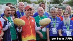 Turkmen President Gurbanguly Berdymukhammedov with officials of the upcoming 2017 Asian Indoor and Martial Arts Games during Melon Day celebrations in Ashgabat on August 18.