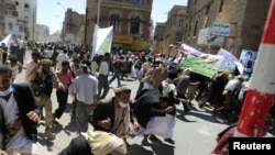 Yemeni antigovernment protesters flee as gunfire erupts during a demonstration in Sanaa on October 16.