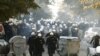 Riot police run down a street during clashes in Belgrade with antigay protesters on October 10.
