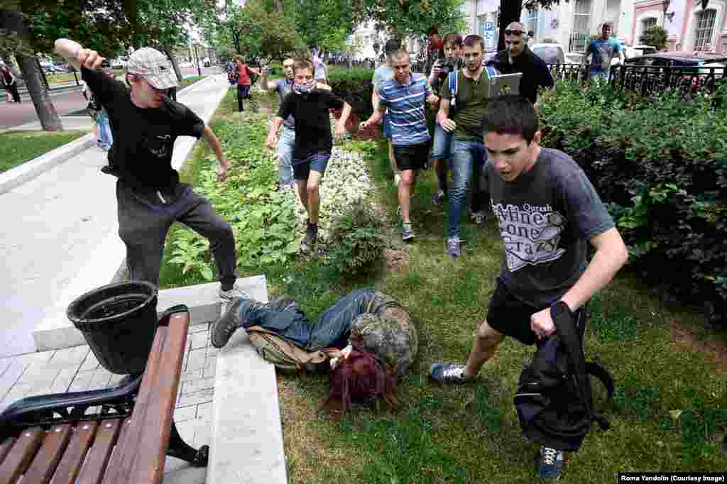 Another participant in the protest against the &quot;gay propaganda&quot; ban being attacked by youths in Moscow. Despite Putin&#39;s public statements,&nbsp;activists say the law he signed prohibiting the spread of gay &quot;propaganda&quot; among minors has encouraged discrimination and violence.&nbsp;Putin has also been criticized for bolstering the careers of homophobic&nbsp;public figures.&nbsp;