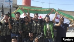 Members of the Free Syrian Army pose for the cameras in Azzaz, Aleppo province, on July 19.