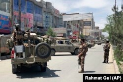 Afghan police arrive at the site of an attack in Kabul on May 12.