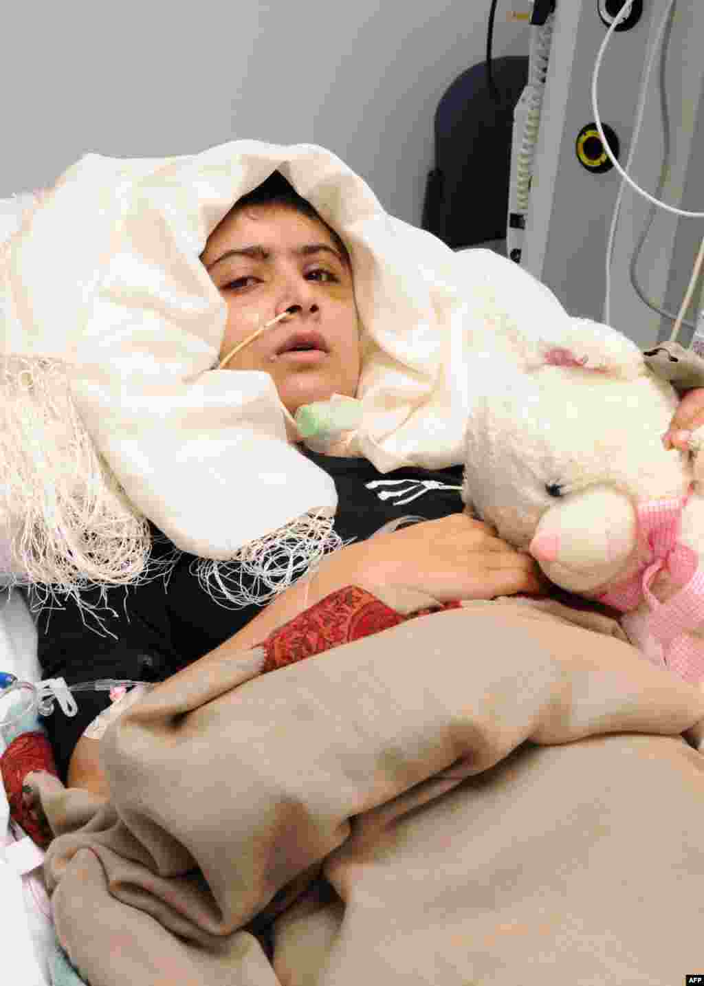 OCTOBER 19, 2012 -- This handout picture received from the Queen Elizabeth Hospital/University Hospitals in Birmingham, England, shows Pakistani schoolgirl Malala Yousafzai lying in her bed after receiving treatment at the hospital. Malala was shot in the head by the Pakistani Taliban for her efforts to promote girls&#39; education in Pakistan. She was transferred to the U.K. for treatment on October 15. (AFP)