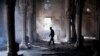 A man walks inside the burnt Rabaa Al-Adawiya Mosque, the morning after the clearing of the sit-in in and around the mosque in Cairo by police in which scores were killed.