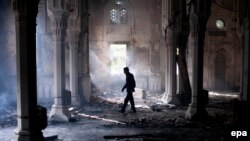 A man walks inside the burnt Rabaa Al-Adawiya Mosque, the morning after the clearing of the sit-in in and around the mosque in Cairo by police in which scores were killed.