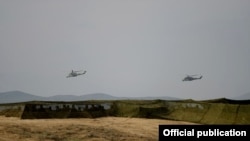 Nagorno-Karabakh - Armenian helicopter gunships fly during military exercises near the Line of Contact, 14Nov2014.