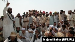 FILE: Residents of the town of Bara in the Khyber tribal district debate the fate of minority Sikhs threatened by a fanatical cleric in 2002.