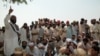 A tribal jirga or council in the Khyber tribal district debate the fate of minority Sikhs threatened by a fanatical cleric in 2002.