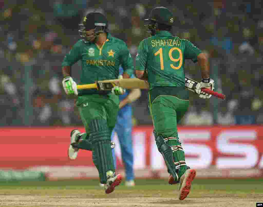 Pakistan&#39;s Sharjeel Khan, left, and Ahmed Shehzad run between the wickets during the World T20 cricket tournament match between India and Pakistan at the Eden Gardens Cricket Stadium in Kolkata on March 19.