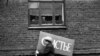 Фото Владимира Соколаева. Женщина с плакатом спешит на первомайскую демонстрацию. Новокузнецк. 1983 