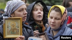 Russian Orthodox believers gather outside a court building during the trial of members of the female punk collective "Pussy Riot" for hooliganism motivated by religious hatred earlier this year. 