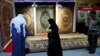 People look at the carpets displayed at the Iran section of the Baghdad International Fair, in Baghdad on November 10.