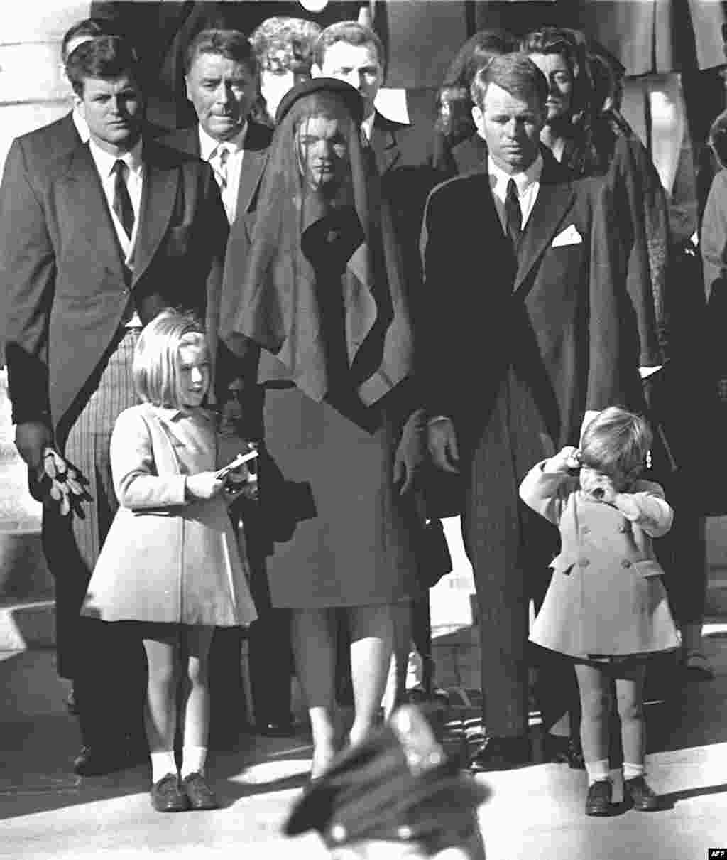 Jacqueline Kennedy stands with her two children, Caroline and John Jr., and brothers-in law Edward (Ted) (back left) and Robert (back right) at President Kennedy&#39;s funeral on November 26, 1963, in Washington, D.C.