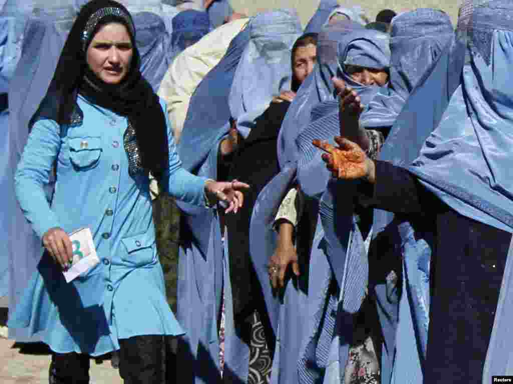 Afghan widows wait to receive monthly rations from the World Food Program in Kabul on October 26.Photo by Omar Sobhani for Reuters