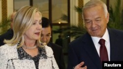 Uzbek President Islam Karimov (right) greets U.S. Secretary of State Hillary Clinton in Tashkent.