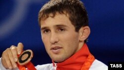 Russian wrestler Besik Kudukhov with his bronze medal on the podium during the Beijing Olympic Games in August 2008