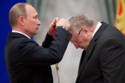 Vladimir Putin (left) presents a state medal to national lawmaker Vladimir Zhirinovsky in 2016.