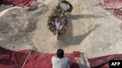 A man prays over the grave site of slain Burhanuddin Rabbani at the Wazir Akbar Khan hilltop overlooking Kabul in 2011.