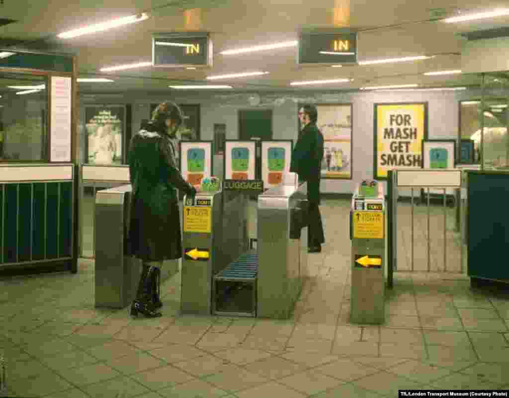 Passengers go through an automatic ticket gate at the Seven Sisters Station in 1969.