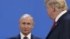 ARGENTINA – US President Donald Trump (R), looks at Russia's President Vladimir Putin as they take place for a family photo, during the G20 Leaders' Summit in Buenos Aires, on November 30, 2018