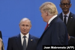 U.S. President Donald Trump (right) looks at President Vladimir Putin as they line up for a photo at the G20 summit in Buenos Aires.