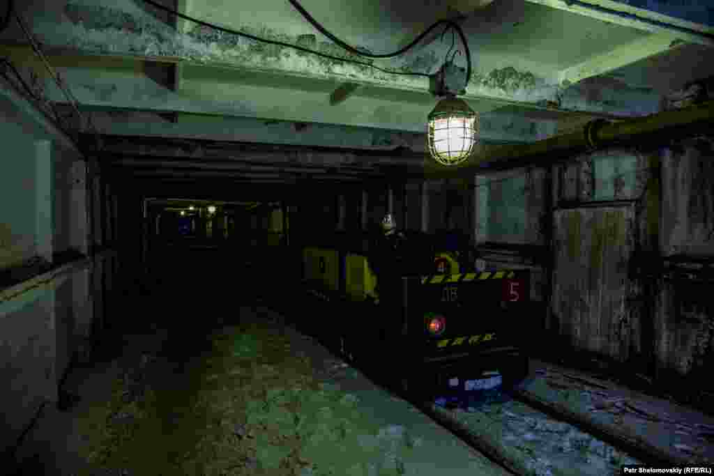 An electric carriage used to transport coal in the Severnaya coal mine lies idle in one of its tunnels.