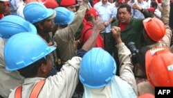 Venezuelan President Hugo Chavez (center) and his Belarusian counterpart, Alyaksandr Lukashenka, visit a housing complex in the central Maracay state of Aragua on March 16.