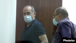 Armenia -- Former President Robert Kocharian (L) and his lawyer Hayk Alumian arrive for the latest session of his trial, Yerevan, June 23, 2020.