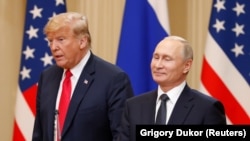 U.S. President Donald Trump and Russian President Vladimir Putin arrive for a joint news conference after their meeting in Helsinki, July 16, 2018.