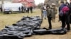 UKRAINE – Ukrainian Prosecutor General Iryna Venediktova, center, looks at the exhumed bodies of civilians killed during the Russian occupation in Bucha, on the outskirts of Kyiv, April 8, 2022