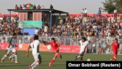 FILE: Players compete during a friendly soccer match between Afghanistan and Pakistan in Kabul in August 2013.
