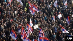 Supporters of the Serbian opposition wave flags during a mass protest in downtown Belgrade on February 5.