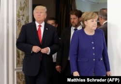 Дональд Трамп и Ангела Меркель во время встречи накануне начала саммита "Большой двадцатки"