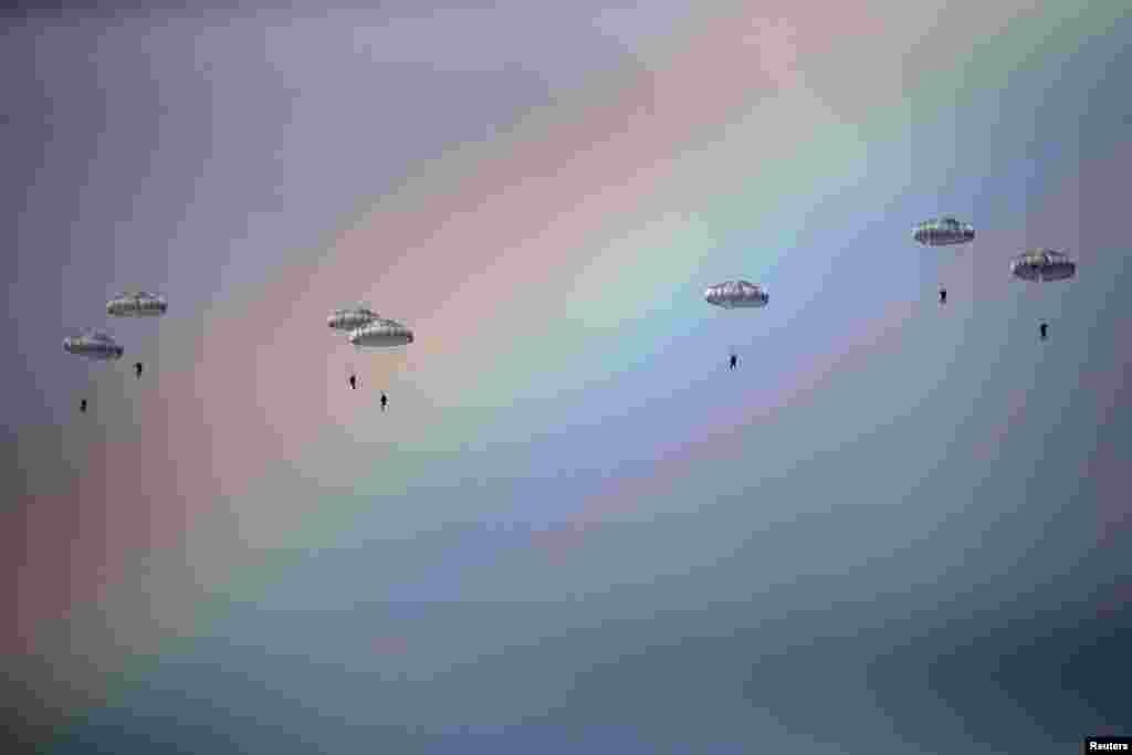 Russian paratroopers jump from an IL-76 transport plane during a joint Serbian-Russian military training exercise in the town of Kovin, near Belgrade. (Reuters/Marko Djurica)
