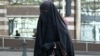 A Muslim woman dressed in niqab walks through the streets of Brussels.