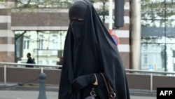 A Muslim woman dressed in niqab walks through the streets of Brussels.